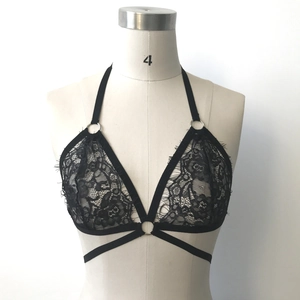 Detail of black eyelash floral lace halter bralette with O-ring and strappy underbust