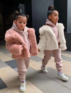 Detail of soft pink faux fur jacket and cozy fleece hoodie set for children fashion