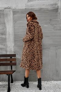 Rear view of a long leopard print faux fur coat with a wide collar and plush texture