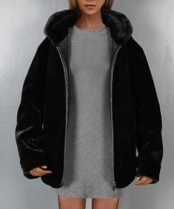 Detail of a women's black faux fur hooded jacket with zipper closure and loose fit