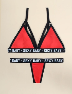 Detail of red sexy lingerie set featuring black elastic bands with Sexy Baby lettering