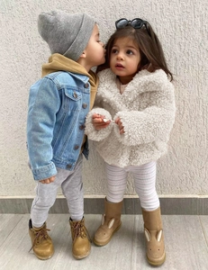Kids' winter fashion featuring blue denim jacket and white faux fur coat for children