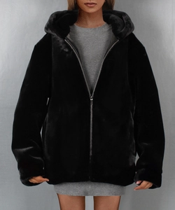Detail of black faux fur hooded jacket with silver zipper and soft plush texture