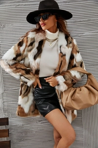 Detail view of tri-color faux fur coat with white brown and black patchwork texture