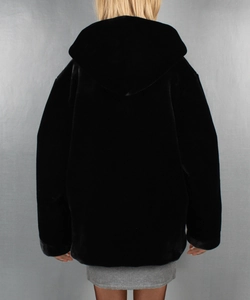 Rear view of women's black faux fur hooded jacket with an oversized silhouette and soft texture