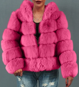 Detail of hot pink faux fur coat featuring horizontal tiered segments and hood