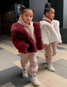 Close-up of children's plush faux fur coat texture and stylish winter streetwear details