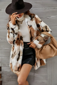 Detailed macro view of faux fur coat texture with irregular brown and black patterns