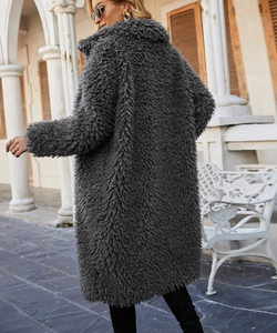 Detail view of the thick texture and grey faux fur material of the long teddy coat