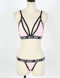 Detailed close-up of pink lingerie set with sexy baby letter straps on mannequin