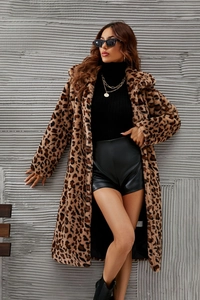 Detailed macro view of the leopard print faux fur texture and long coat material