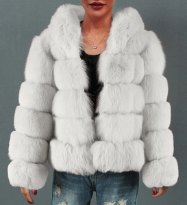 Detail of white faux fur jacket featuring horizontal stripe stitching and plush texture