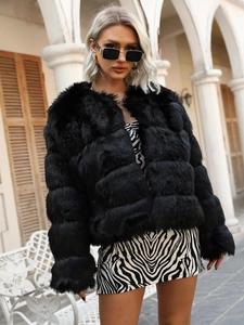 Detail view of the soft black faux fur jacket texture and horizontal layered stitching