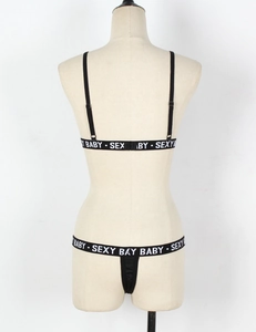 Rear view detail of black lingerie set with Sexy Baby lettered elastic straps on model