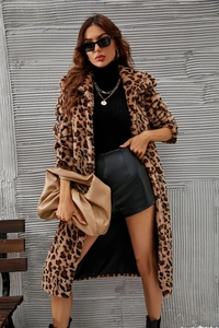 Detail of a luxurious long leopard print faux fur coat with a plush texture and urban style