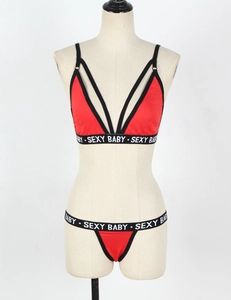 Detail view of red and black lingerie set with Sexy Baby elastic logo straps
