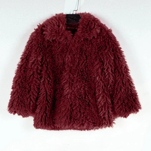 Detail of burgundy faux fur jacket featuring plush long texture and large lapel collar