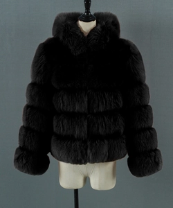 Detail of hooded black faux fur coat showing horizontal panel stitching and plush texture