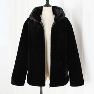 Macro shot of thick black faux fur material and front zipper on the hooded jacket