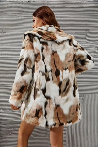 Detail view of the plush faux fur texture and abstract pattern on back of the coat