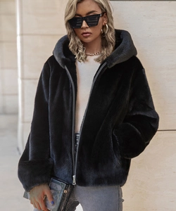 Close-up of black faux fur hooded jacket with premium metal zipper and thick plush texture
