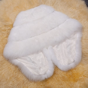 White faux fur bridal shawl wrap with silky floral lining on golden carpet