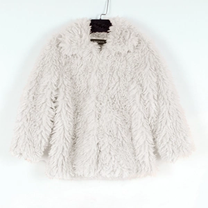 Detail of white shaggy faux fur coat showing plush texture and classic lapel collar