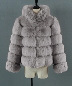 Close-up of gray faux fur jacket featuring horizontal paneled texture and hooded design