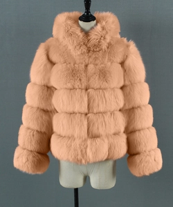 Close-up of horizontal faux fur layers and plush texture on apricot hooded jacket
