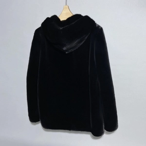 Detail of premium black faux fur hooded jacket with thick plush texture on a hanger