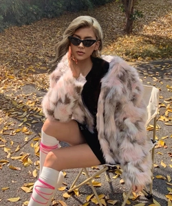 Outdoor shot of a cropped colorful faux fur coat with large lapels and plush texture