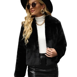 Chic women's short black faux fur jacket with lapel collar and fluffy texture in studio