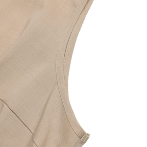 Detail view of khaki jumpsuit fabric texture and durable double-stitch sewing seams