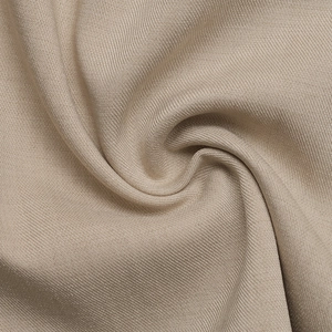 Detailed macro shot of beige woven fabric texture with elegant soft folds and drape