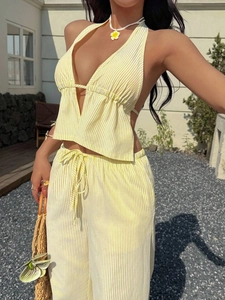 Detail view of yellow striped summer two-piece set with halter neck top and wide leg pants