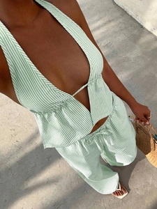 Detail of green striped halter top and matching wide-leg pants set with drawstring waist