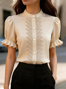 Close-up of stand collar lace patchwork and puff sleeves on apricot summer blouse