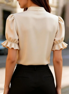 Back view of apricot short sleeve blouse with puff sleeves and ruffled lace cuffs