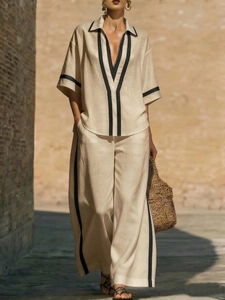 Women's casual beige linen two-piece set with black contrast trim and wide-leg trousers