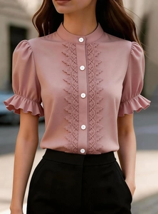 Detail of pink chiffon blouse featuring stand collar, lace trim and ruffle puff sleeves
