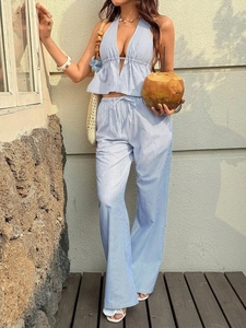 Detail of blue and white striped halter top and high-waist wide-leg trousers for summer