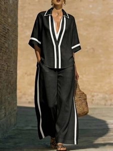 Women's casual black linen set with contrast piping: loose shirt and wide-leg trousers