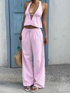 Detail of pink and white striped two-piece summer set with halter top and wide-leg trousers