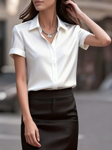 Detail of white satin short-sleeved button-down shirt with high-gloss finish and rolled cuffs