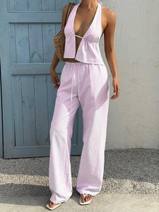 Detail of pink striped halter top and drawstring wide leg trousers in a resort style set