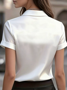 Detailed back view of white short-sleeve satin shirt showing smooth glossy fabric texture