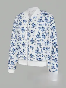 Detailed view of white bomber jacket featuring blue floral pattern and ribbed collar details