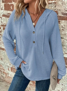 Detail of light blue waffle knit hoodie with V-neckline buttons and matching drawstring