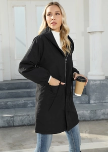 Detail of black hooded mid-length parka with waist drawstring and large patch pockets