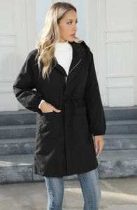 Detail of black hooded parka jacket featuring adjustable waist drawstring and large pockets